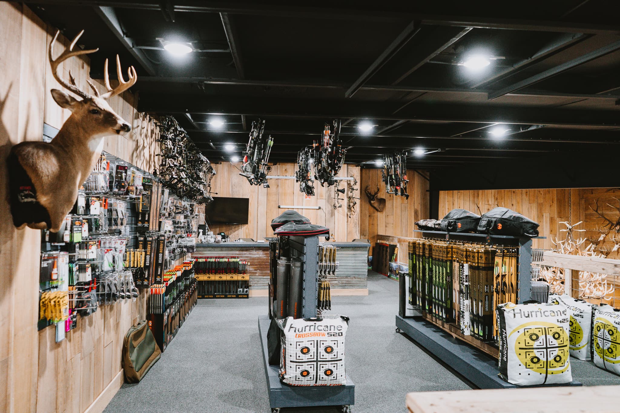 Archery equipment on display inside Sip Outdoors